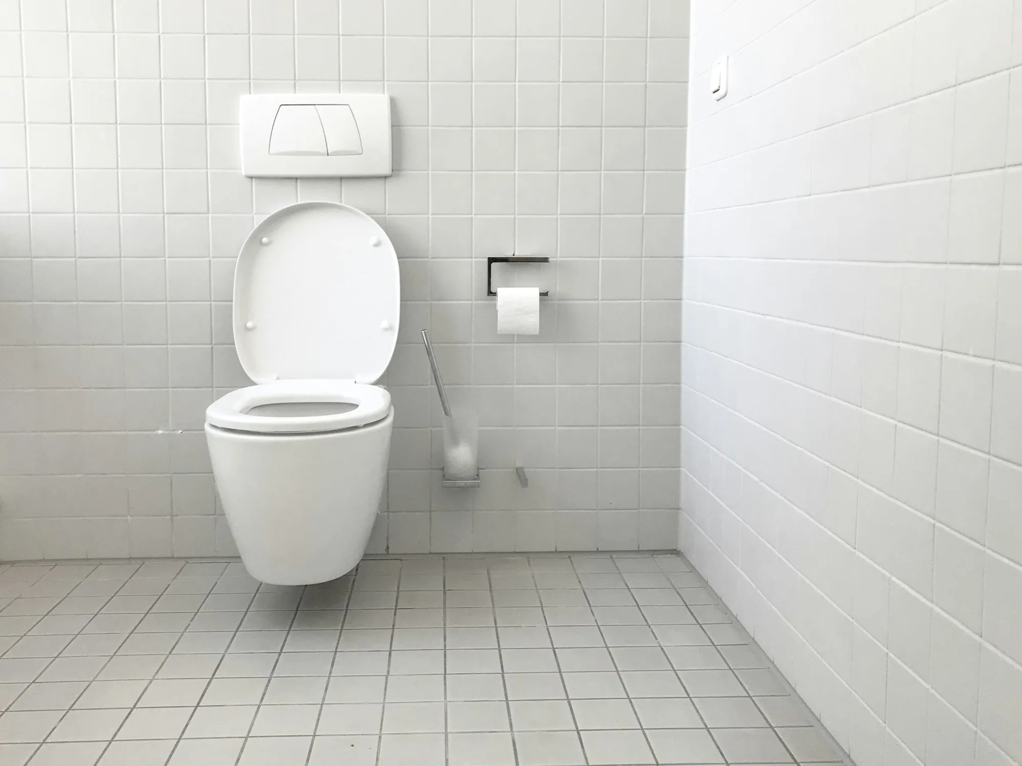 Clean white tiled restroom