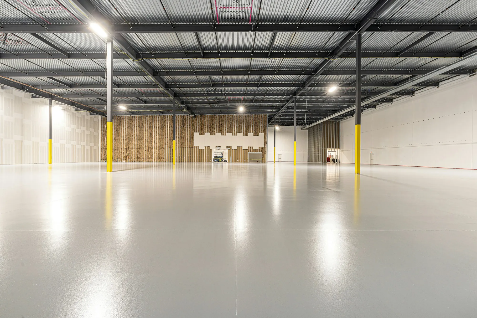 Bright warehouse with yellow columns and a clean floor